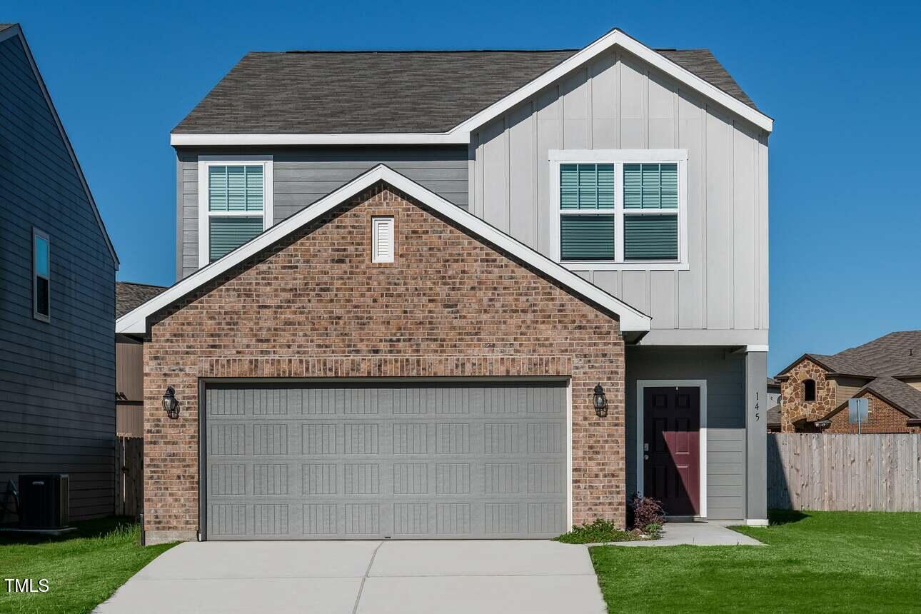 a front view of house with yard and outdoor seating