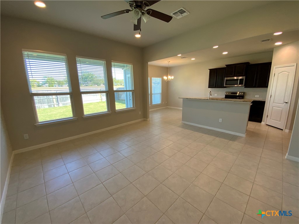 a view of an empty room with a kitchen