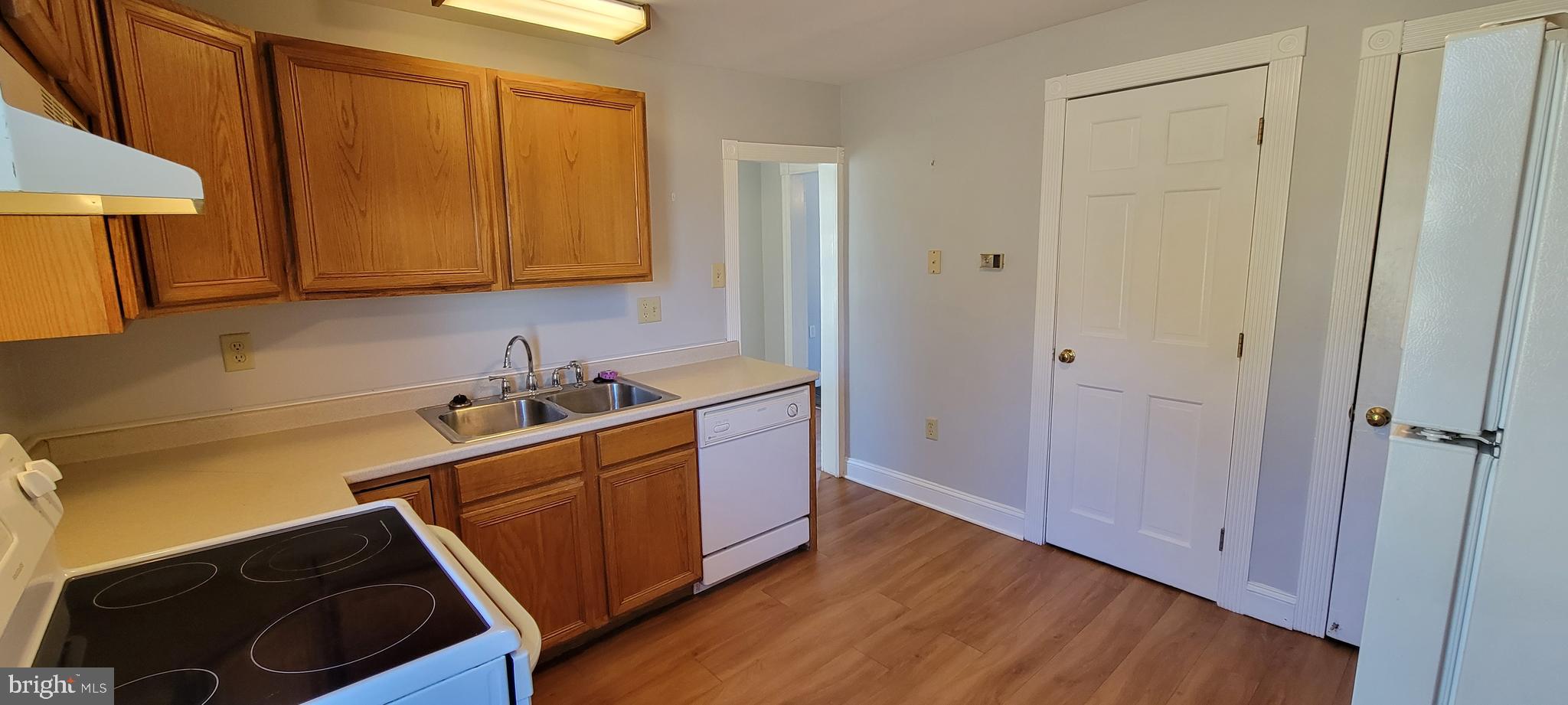 a kitchen with wooden cabinets and sink