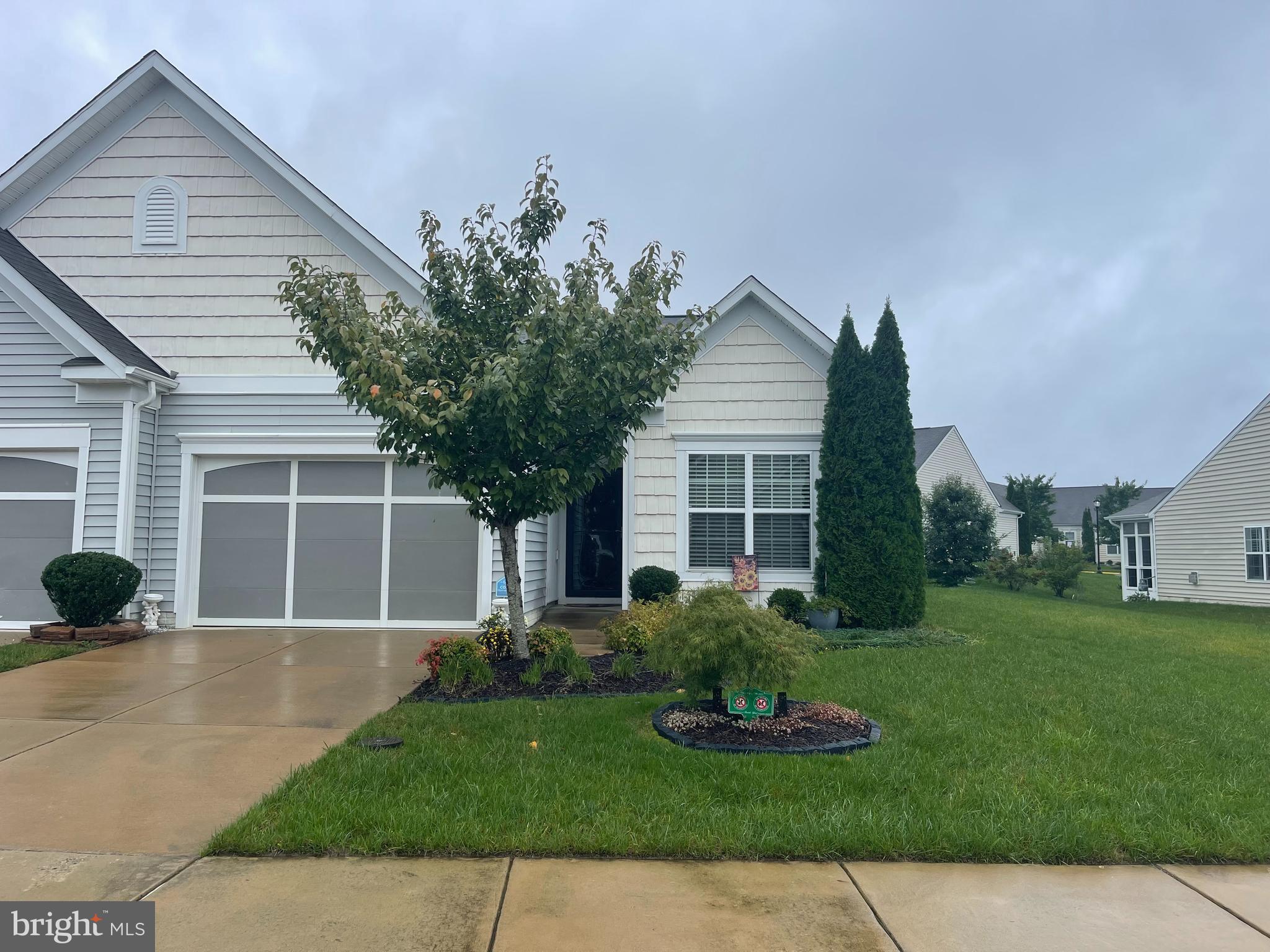 a view of a house with a yard and plants