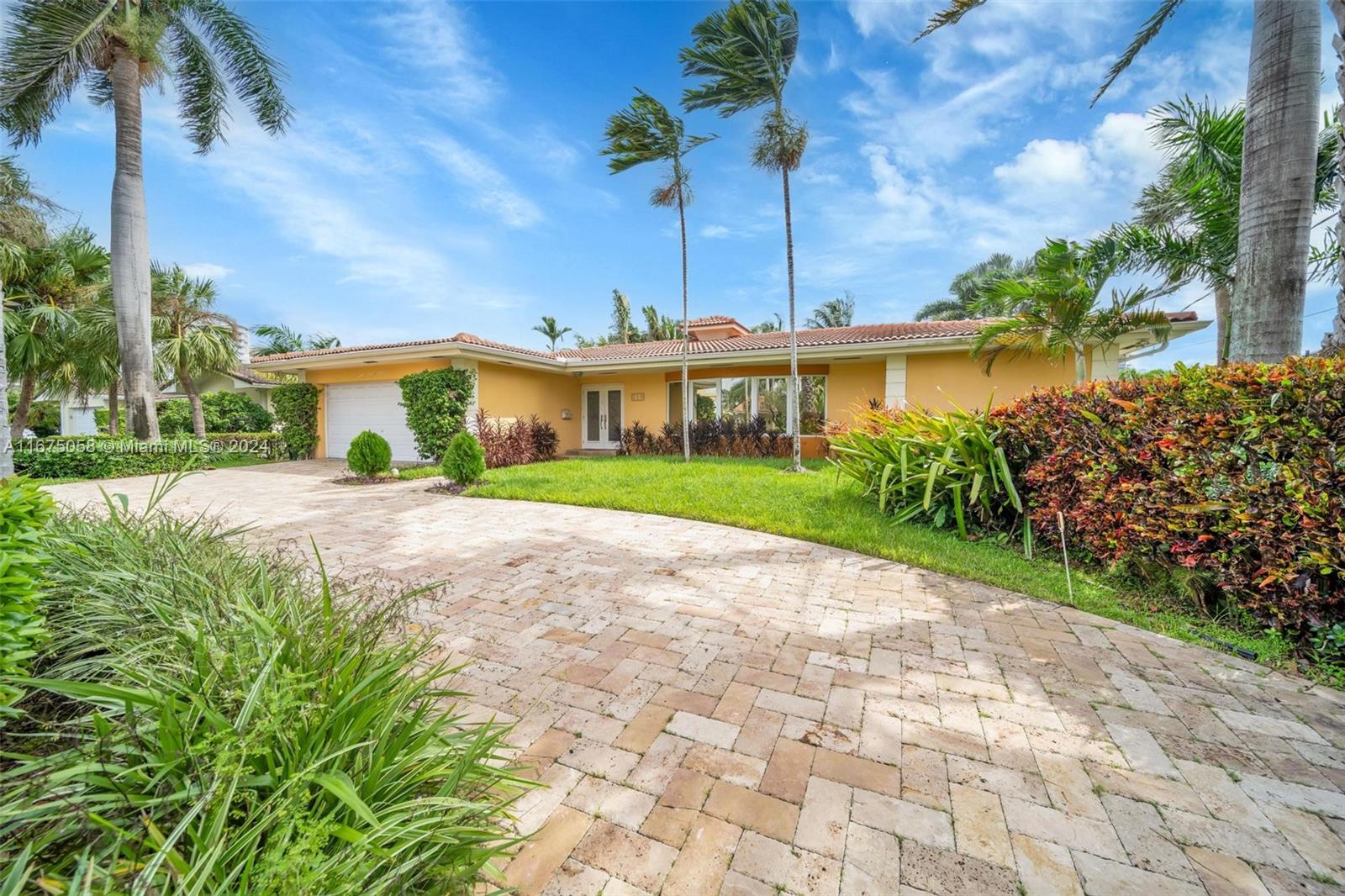 a view of house with a yard and potted plants