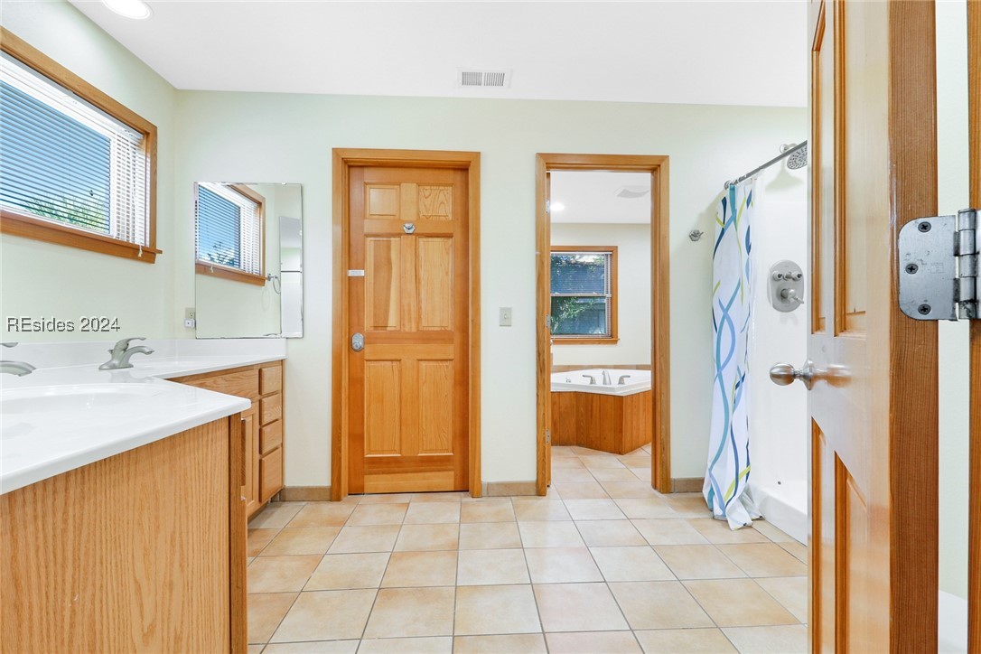 Bathroom with shower with separate bathtub, vanity