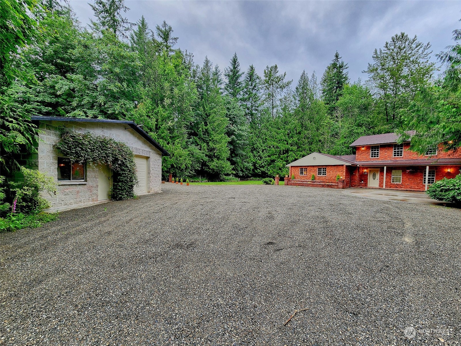 a view of a house with a yard and sitting area