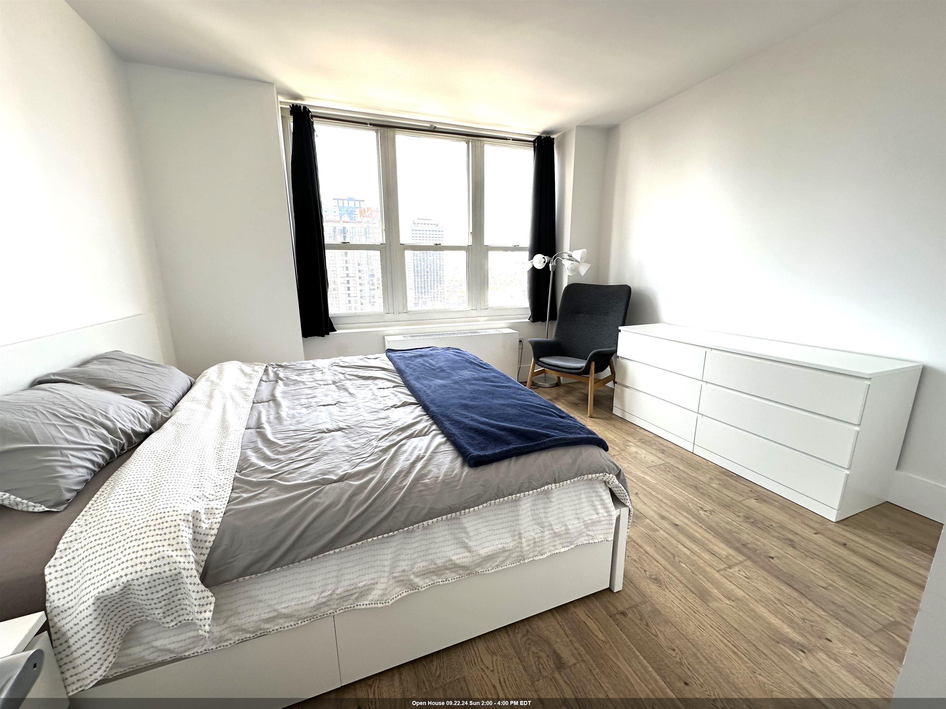 a bed sitting in a bedroom next to a window