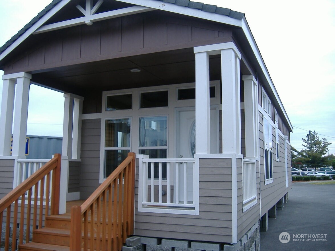 a view of a house with wooden door and deck