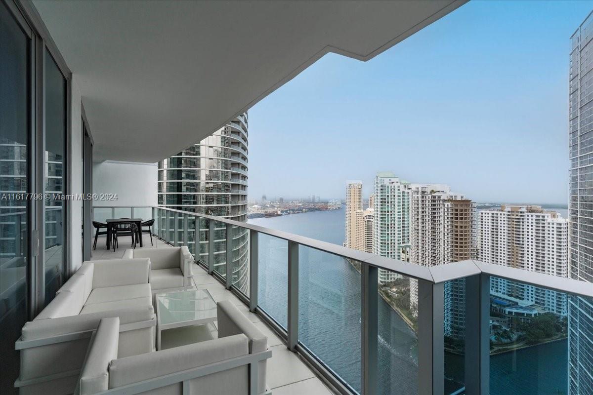 a view of city from balcony with outdoor seating