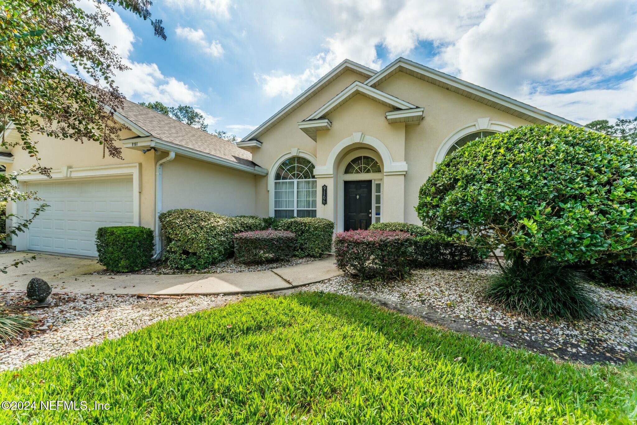 a front view of a house with a yard