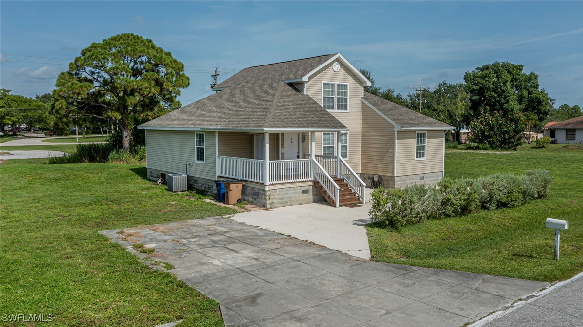 a front view of house with yard and green space