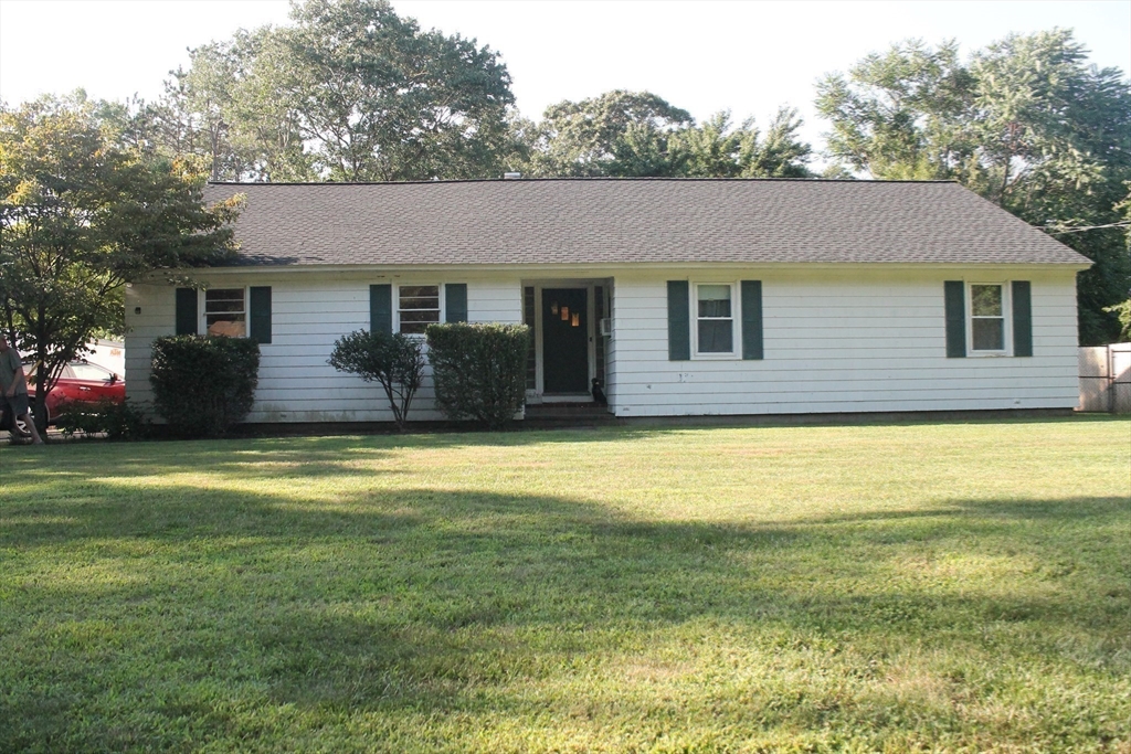 a front view of a house with a yard