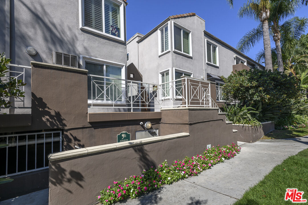 a view of a house with brick walls and a small yard