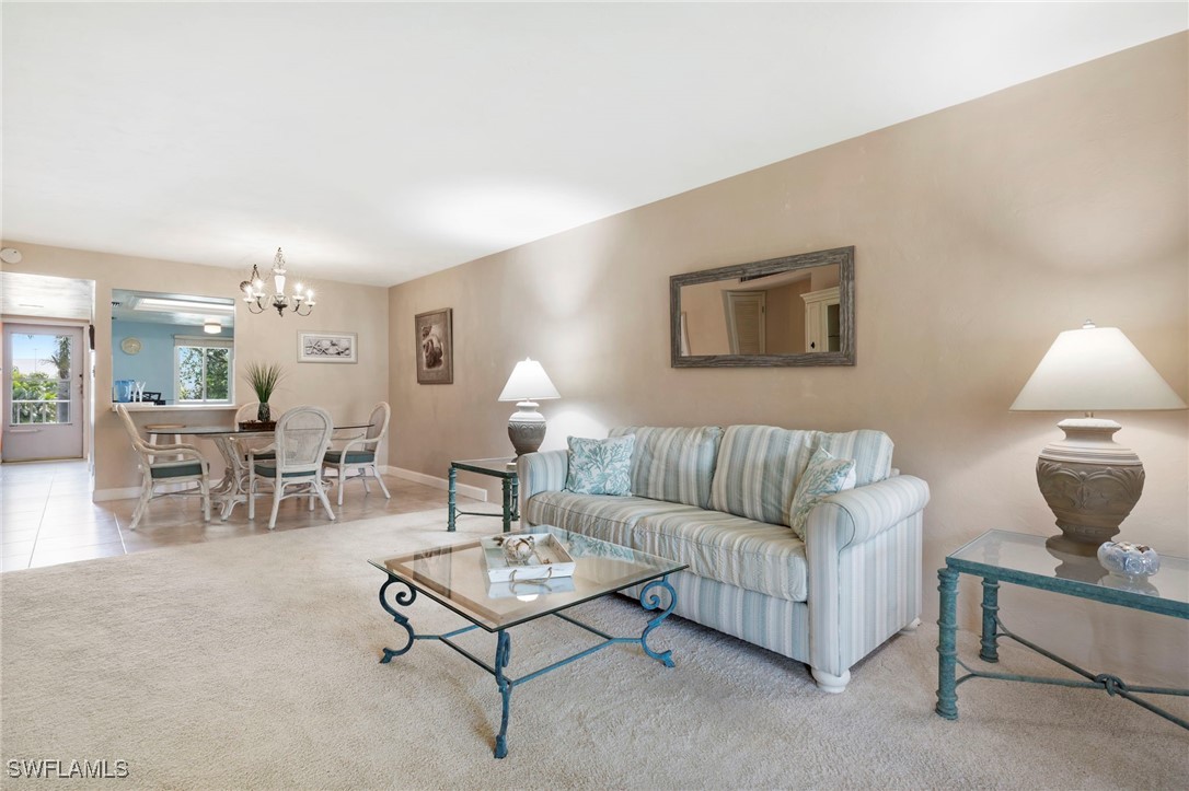 a living room with furniture and a lamp