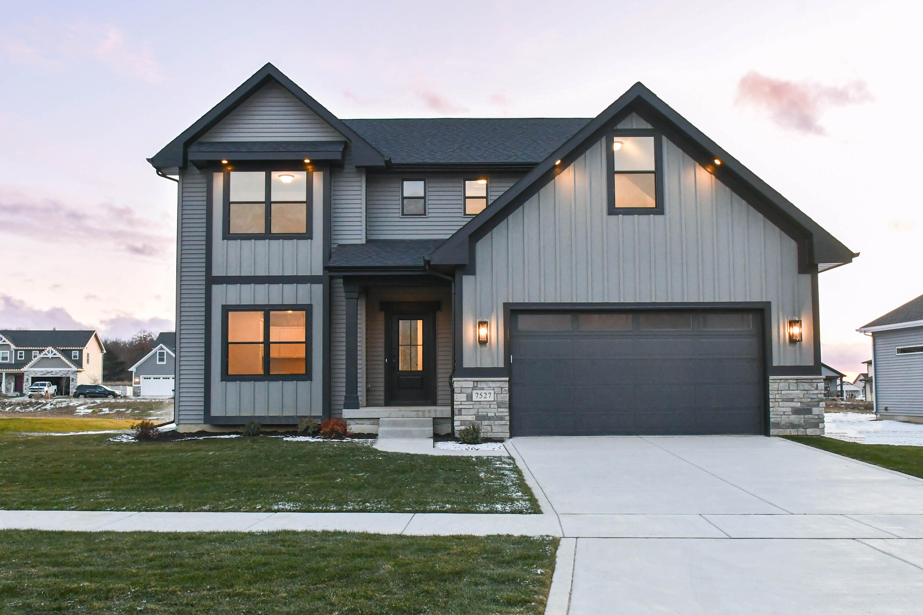 a front view of a house with a yard and garage