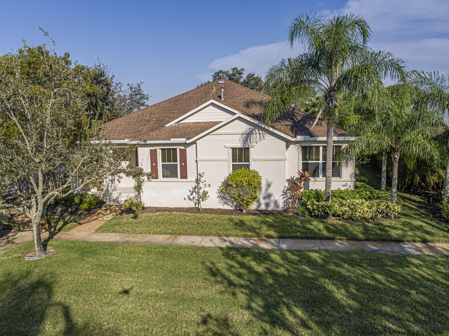 a front view of a house with a garden and yard