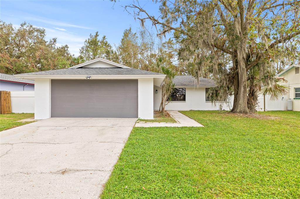 a front view of a house with a yard garage and outdoor seating