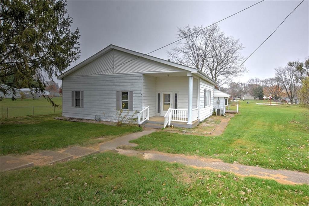 a front view of house with yard and green space