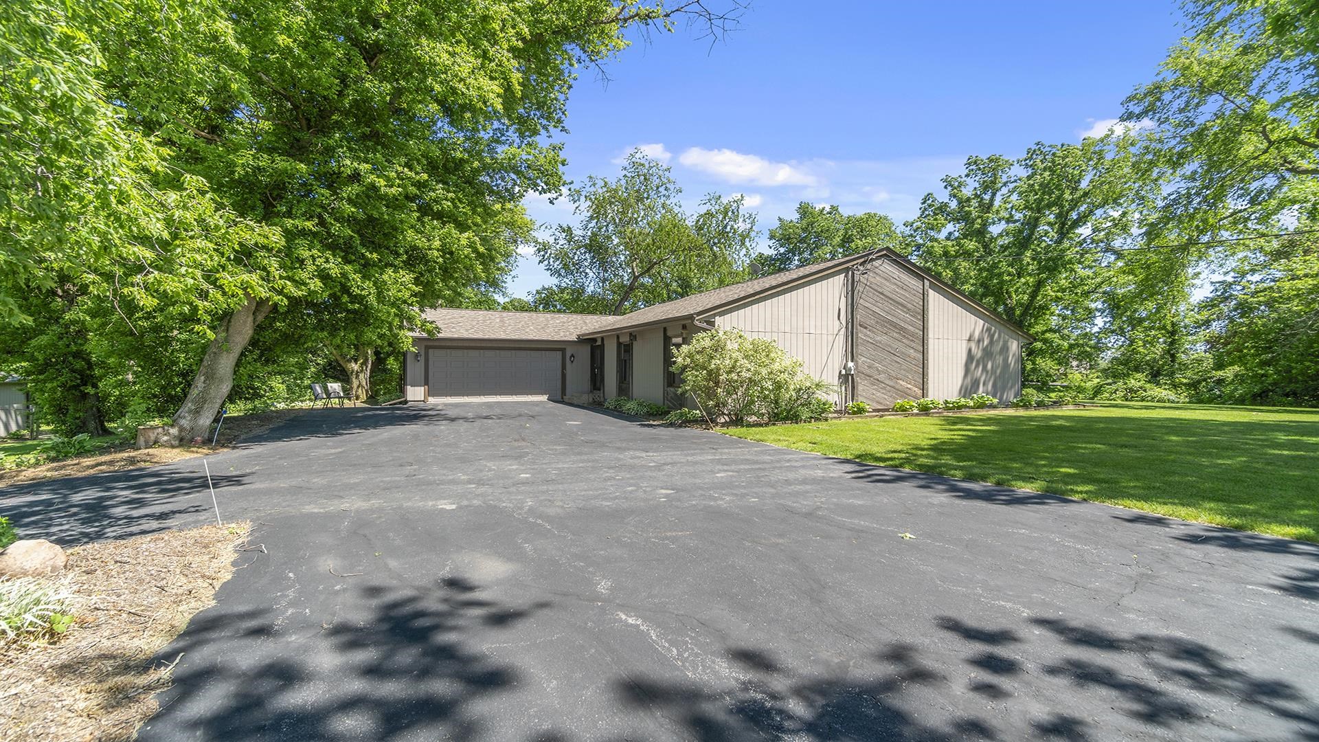 a view of a house with backyard and tree