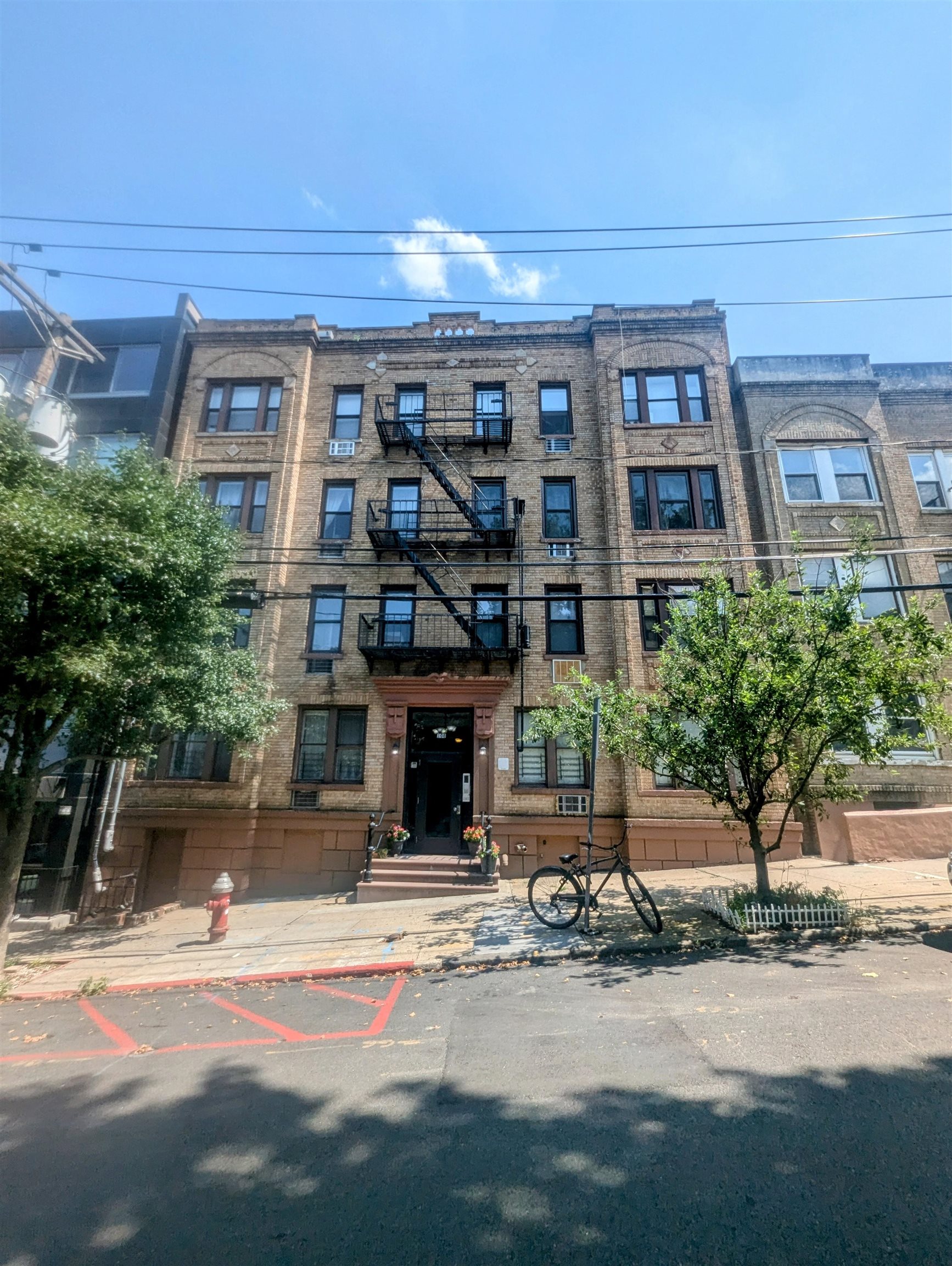 a front view of a building and car parked