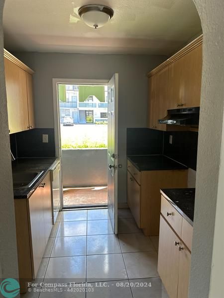 a kitchen with a refrigerator and a stove