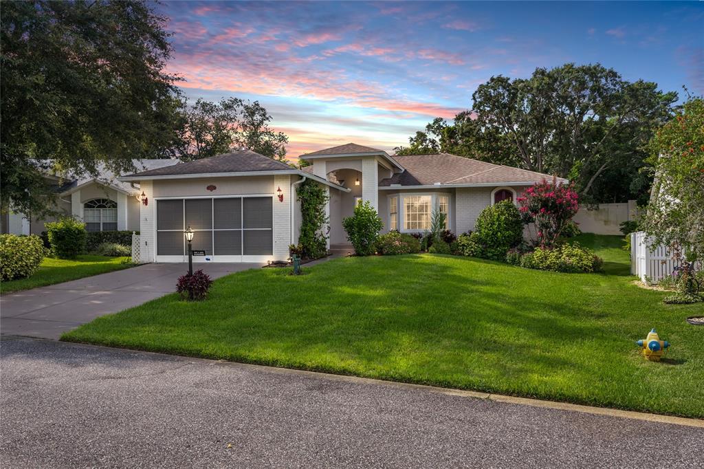 a front view of a house with a garden and yard