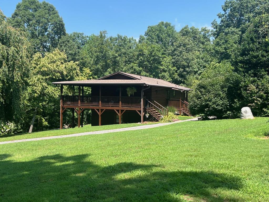 a view of a house with a backyard