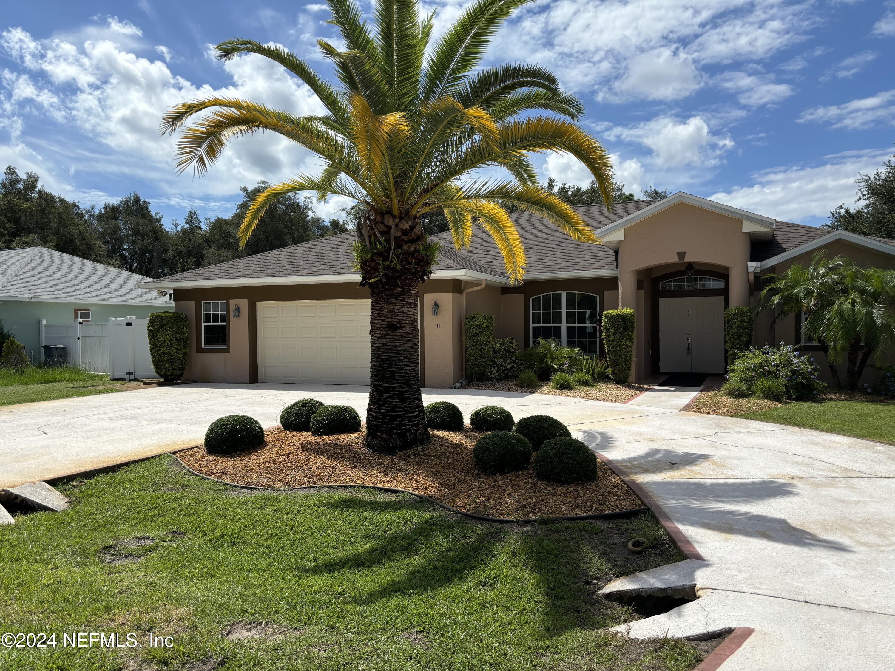 a view of a house with backyard and swimming pool