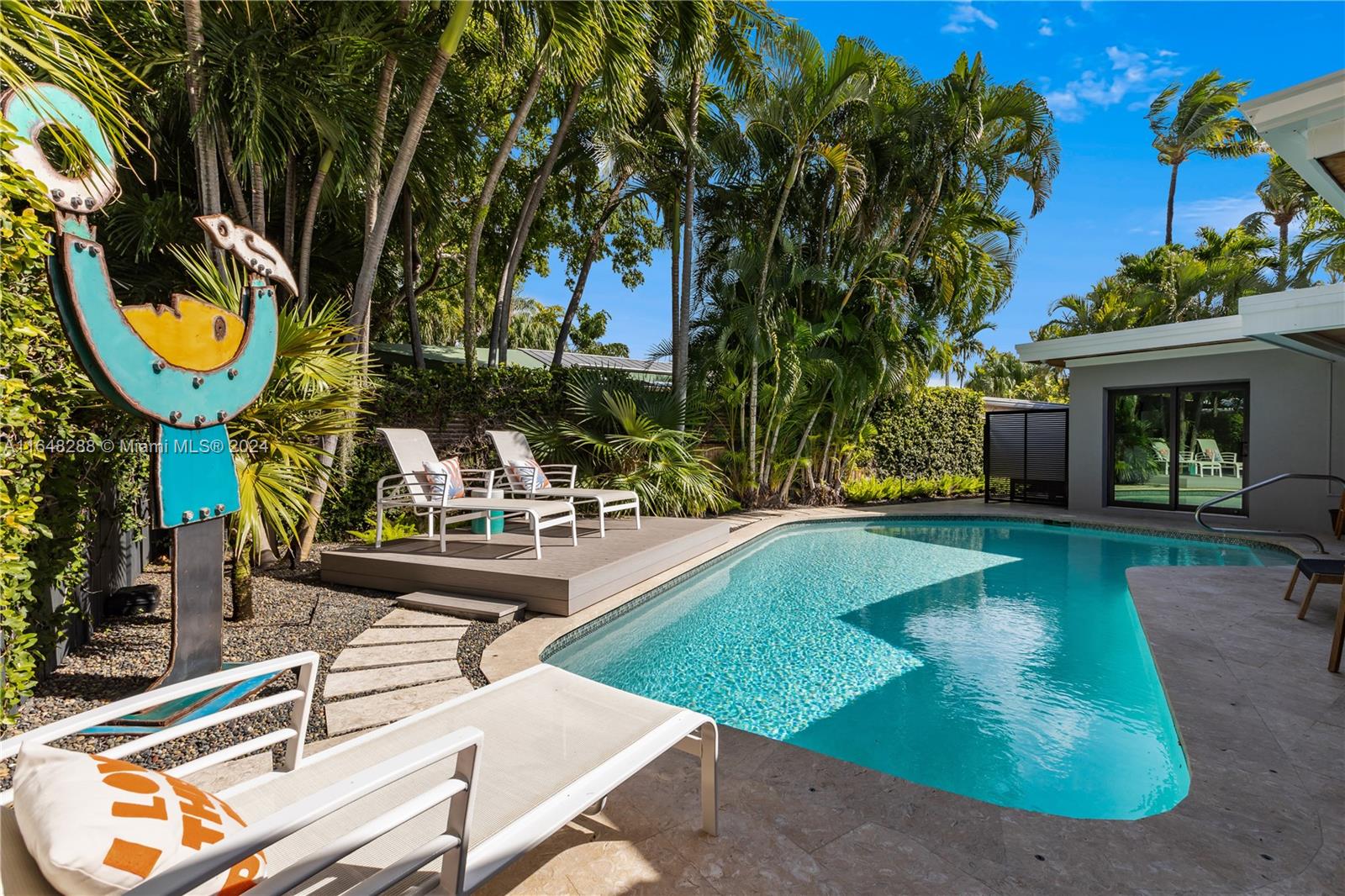 a view of a house with swimming pool and sitting area