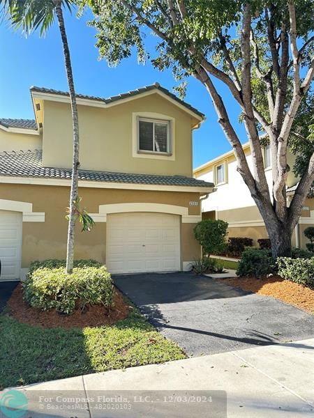 a front view of a house with garage