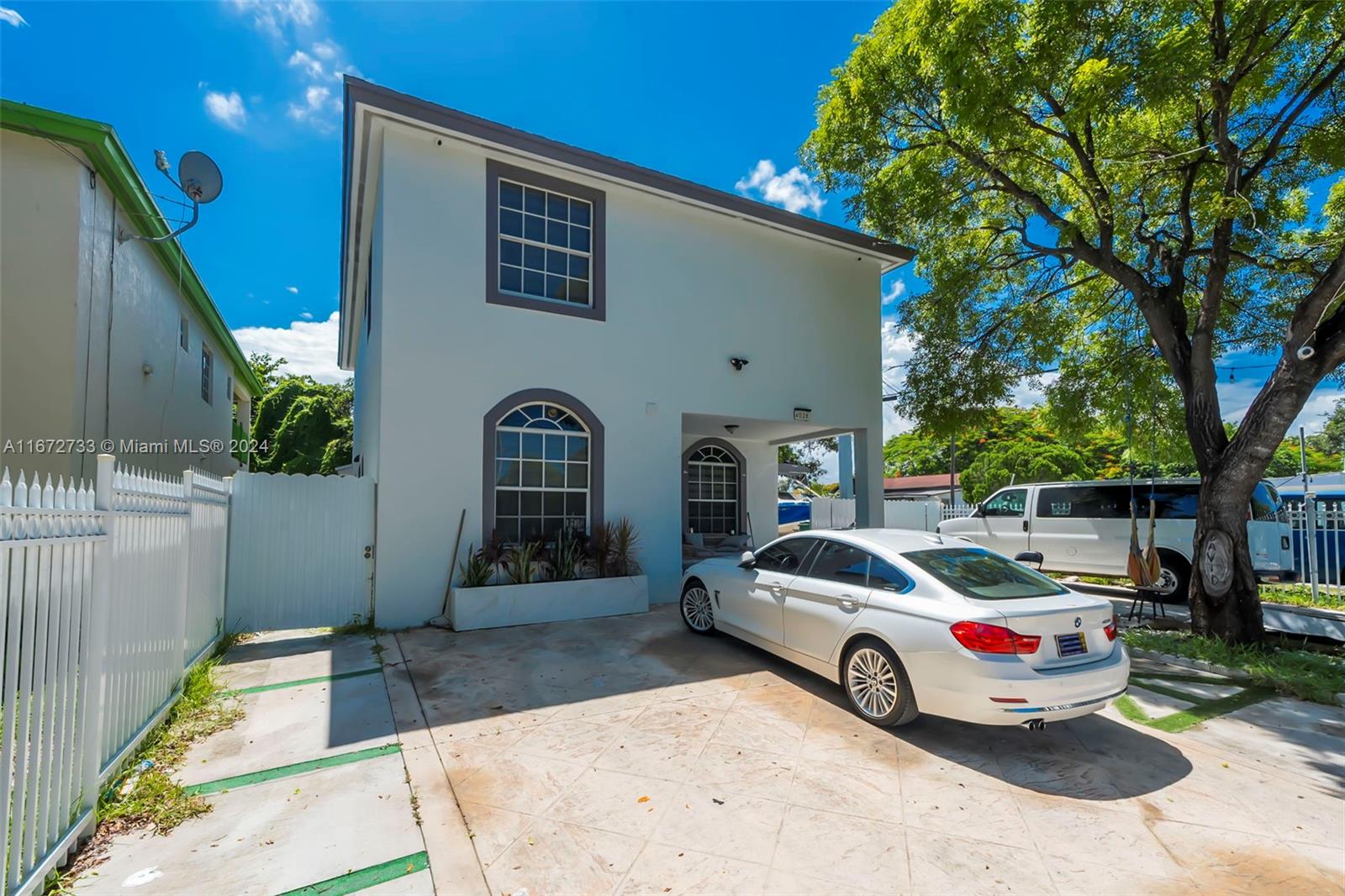 a front view of a house with parking space