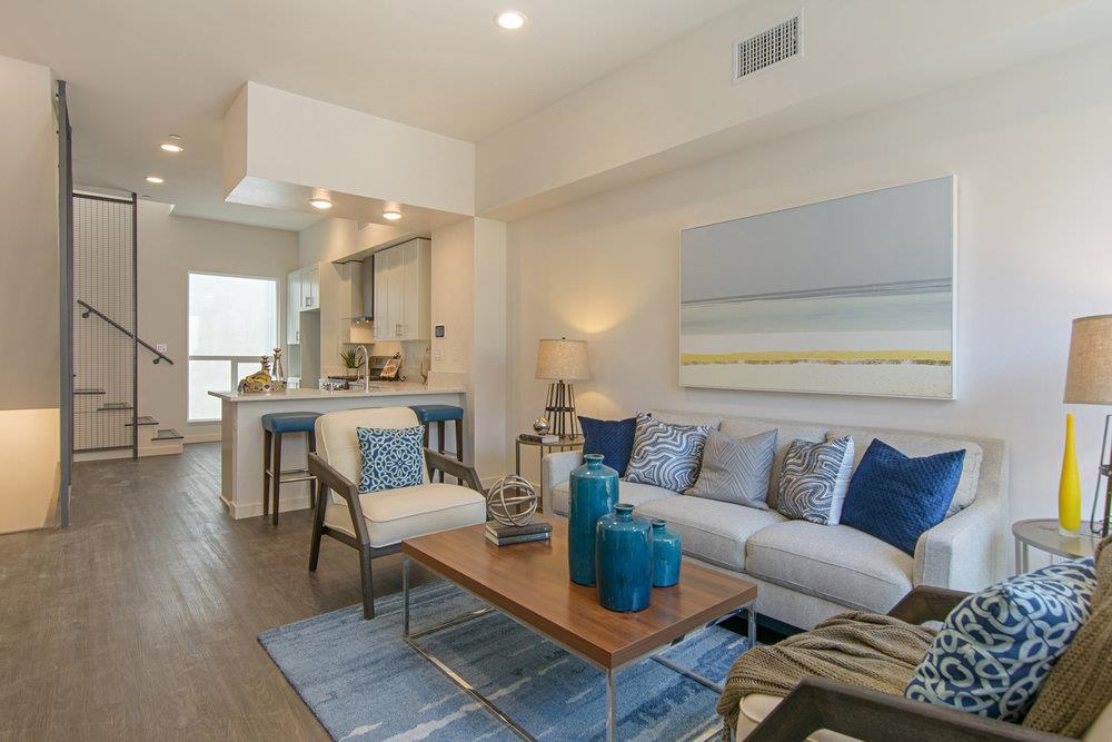 a living room with furniture and kitchen view