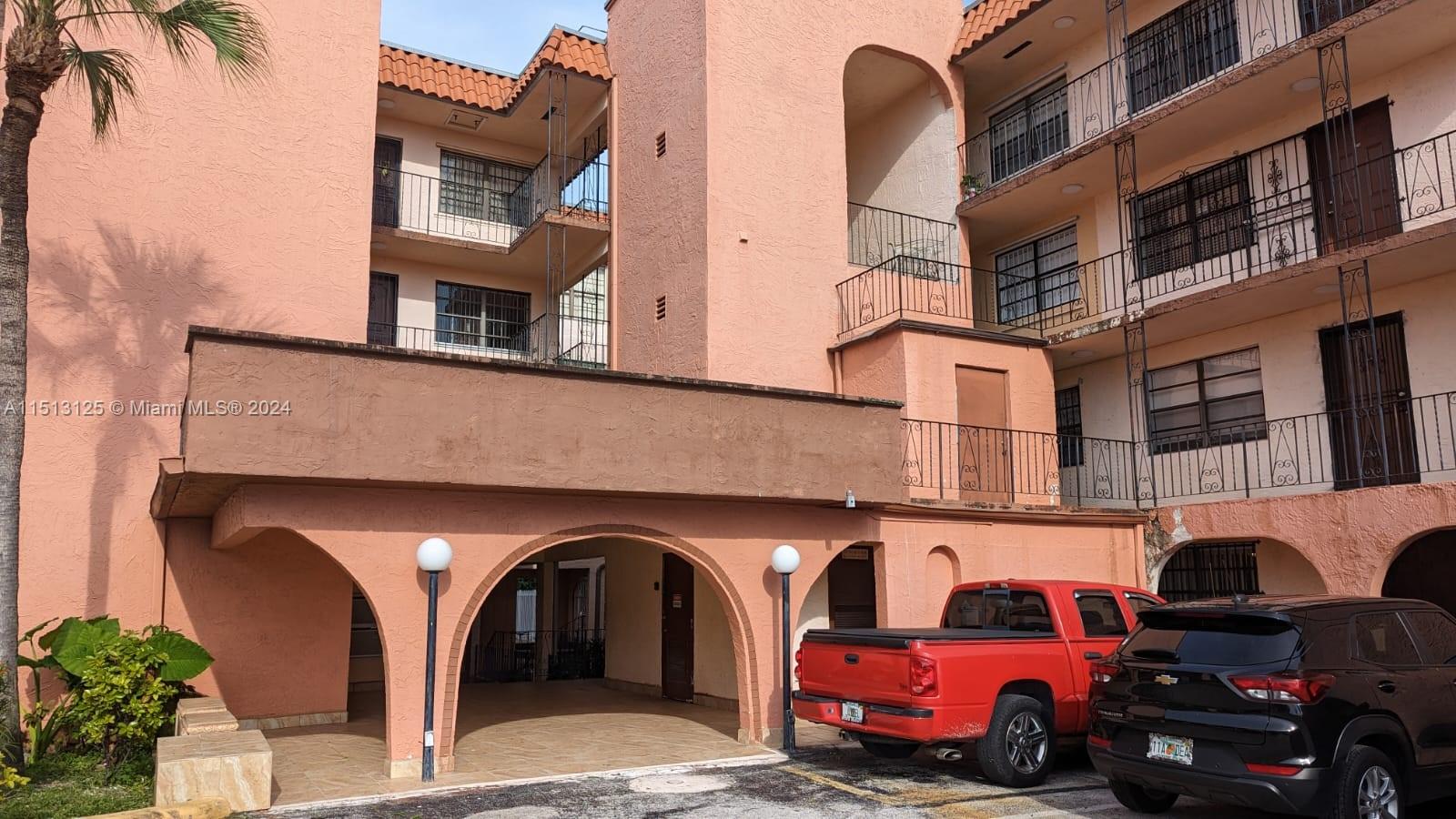 a front view of a building with parking