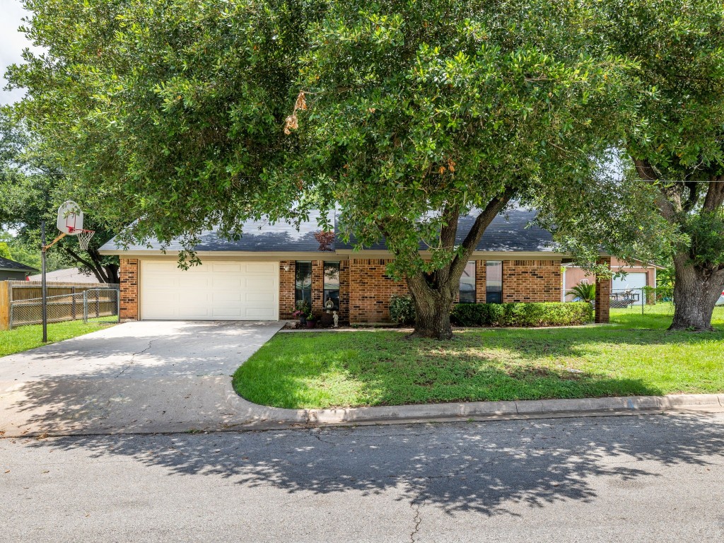 a front view of a house with a yard and a garage