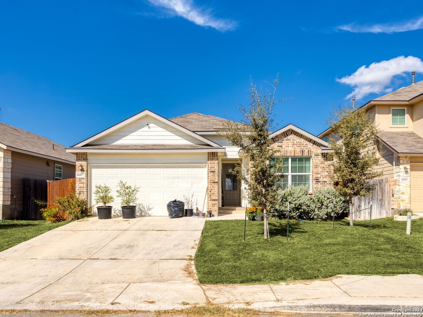 a view of a house with yard and a garden