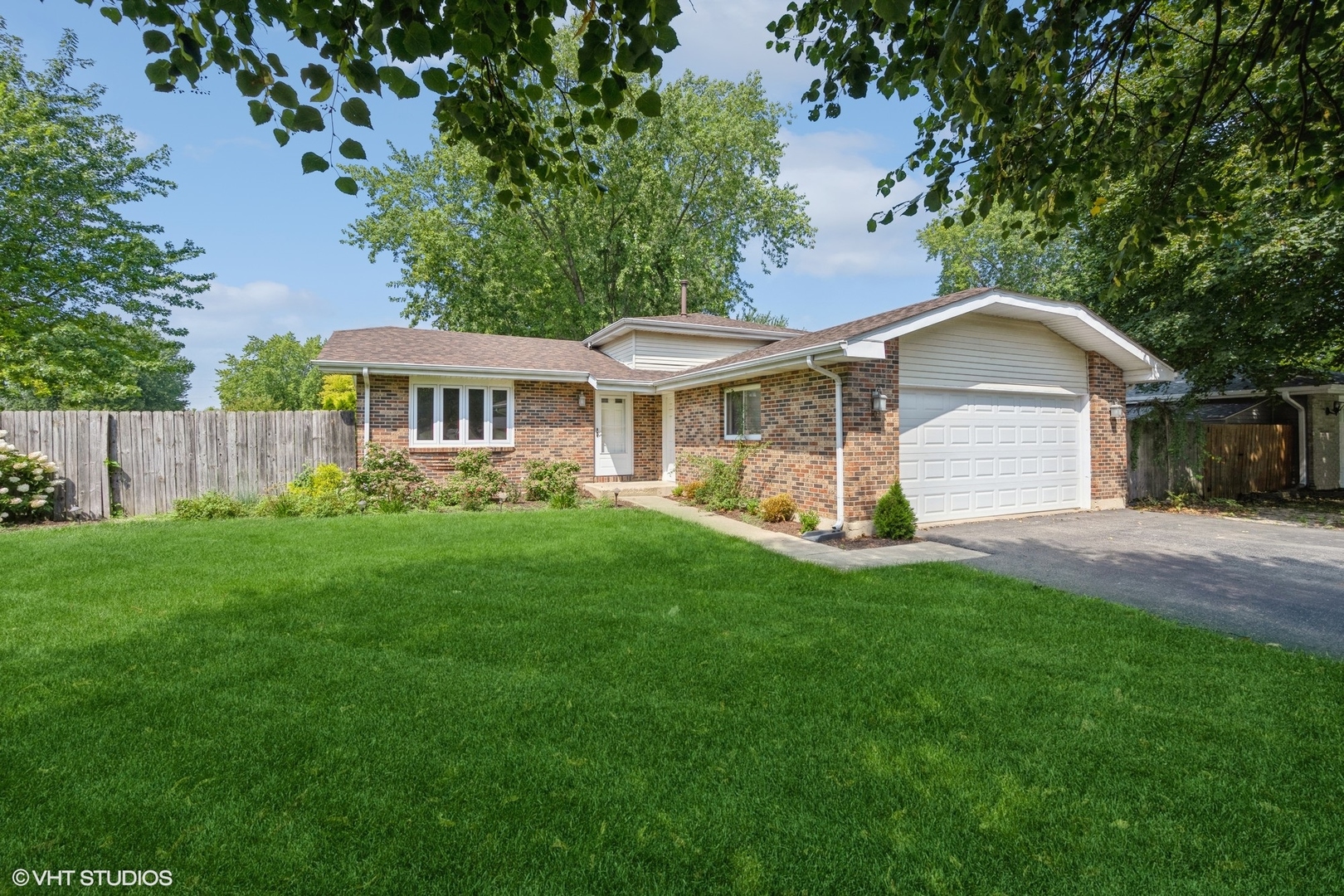 a view of a house with a yard and sitting area