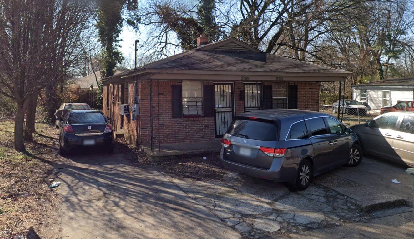 a front view of a house with parking space