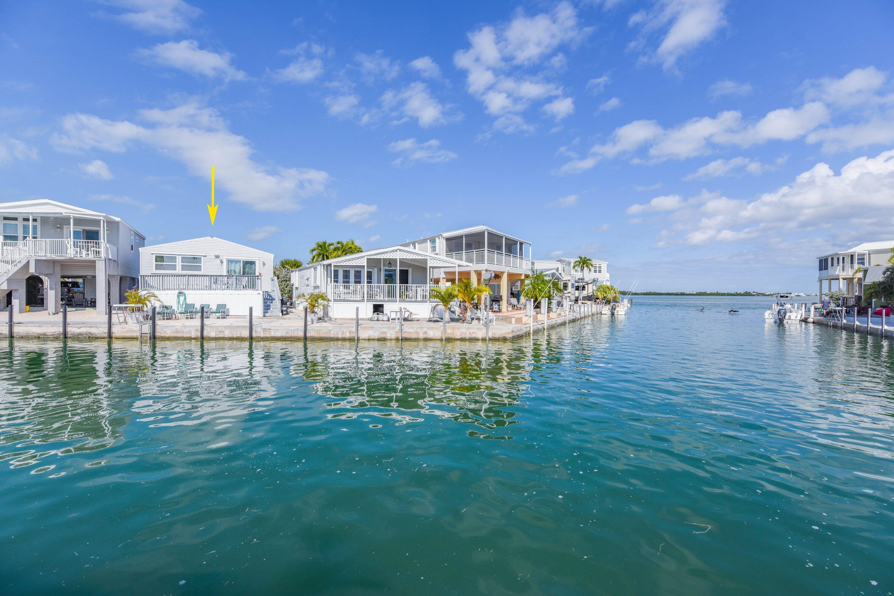 a view of a lake with a house in the background