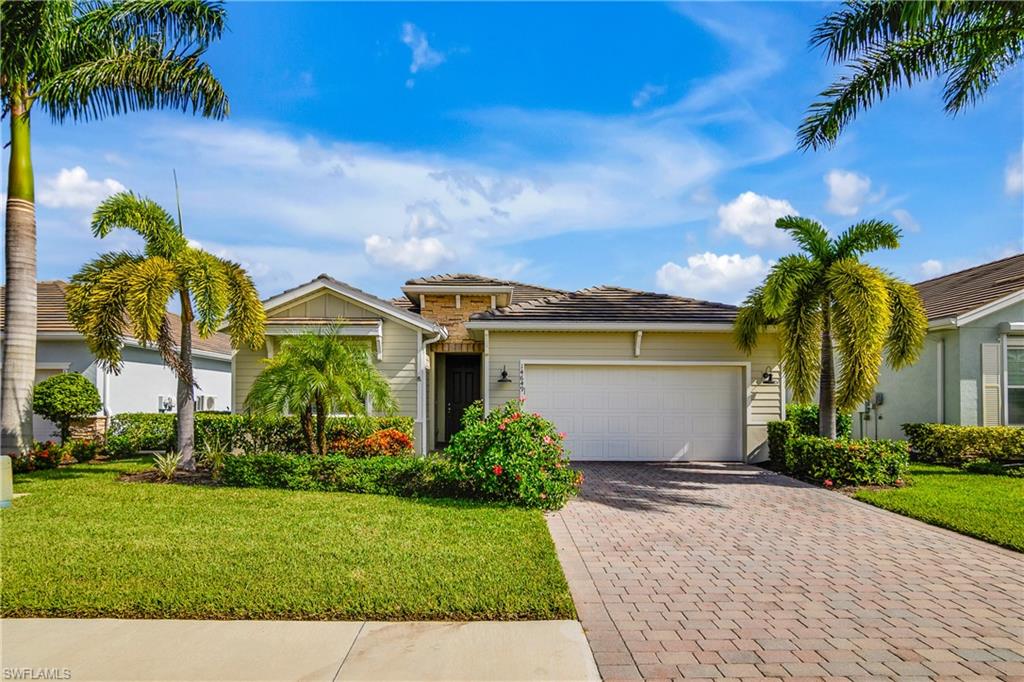 View of front of home with a garage and a front yard