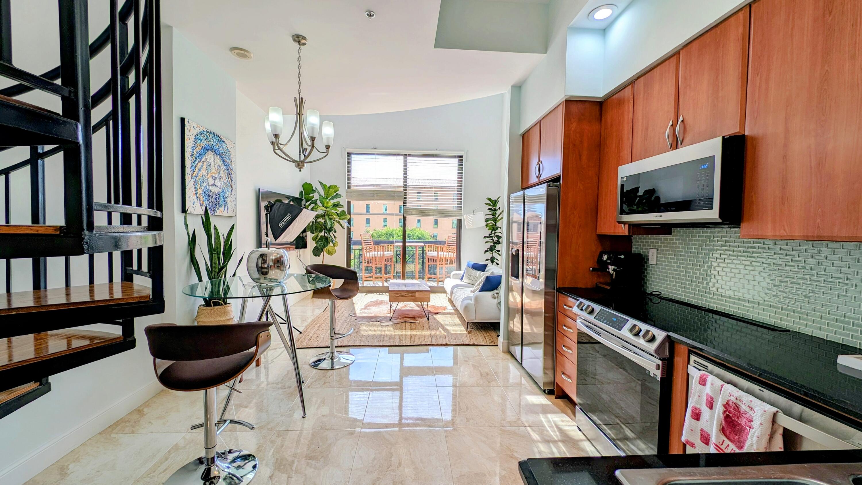 a living room with furniture a flat screen tv and a floor to ceiling window