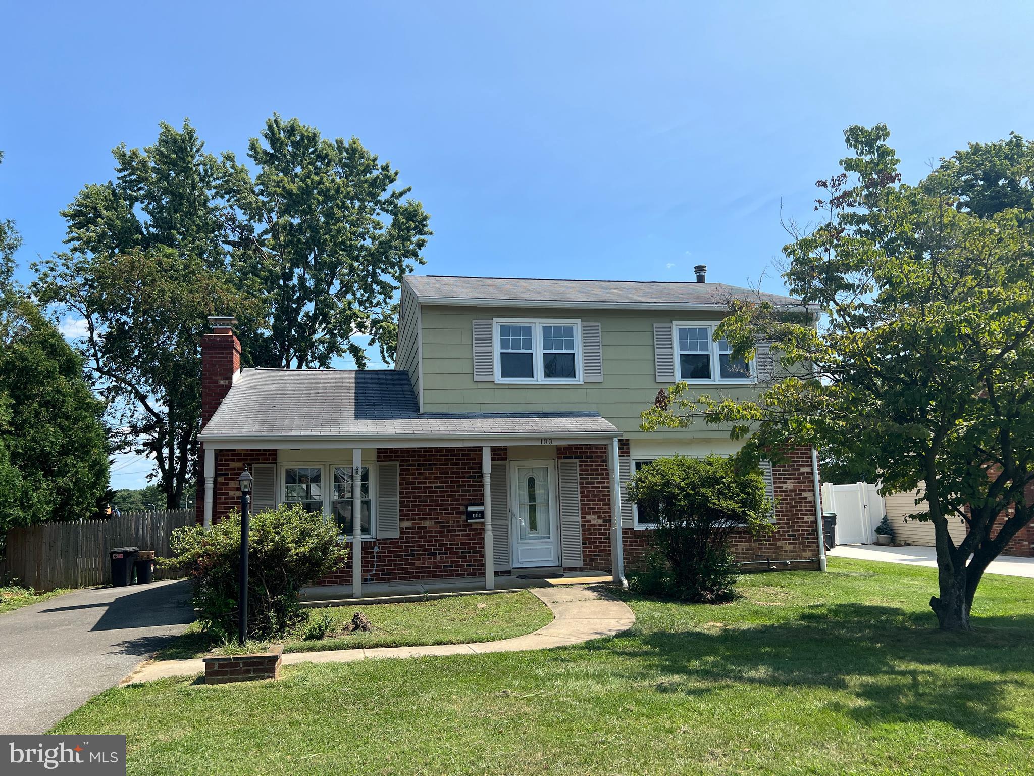 a front view of a house with a garden and plants