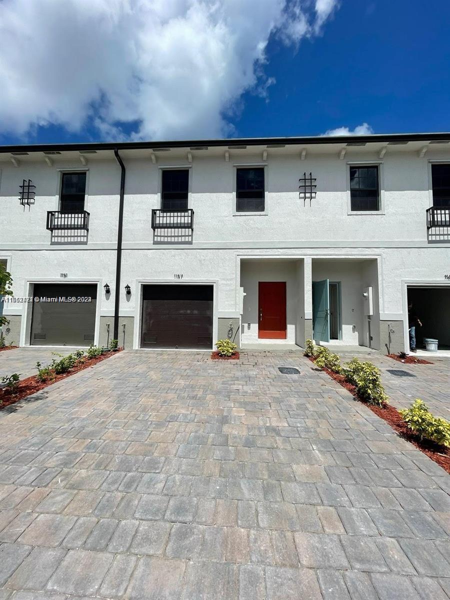 a front view of a house with yard