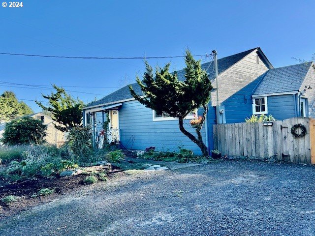 a house that has a tree in front of it