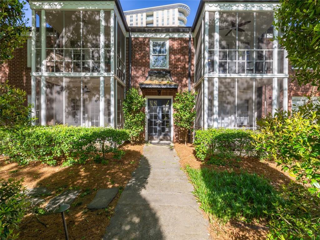 front view of a brick house with a large window