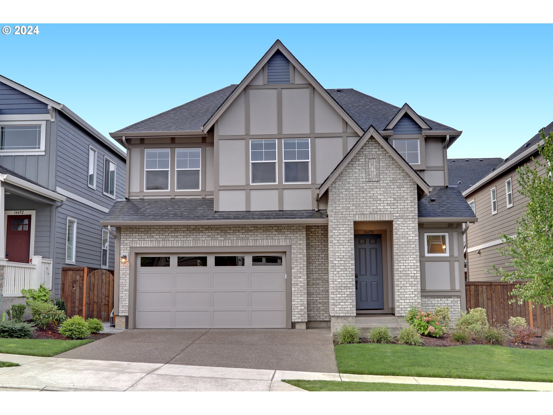 a front view of a house with a yard and garage