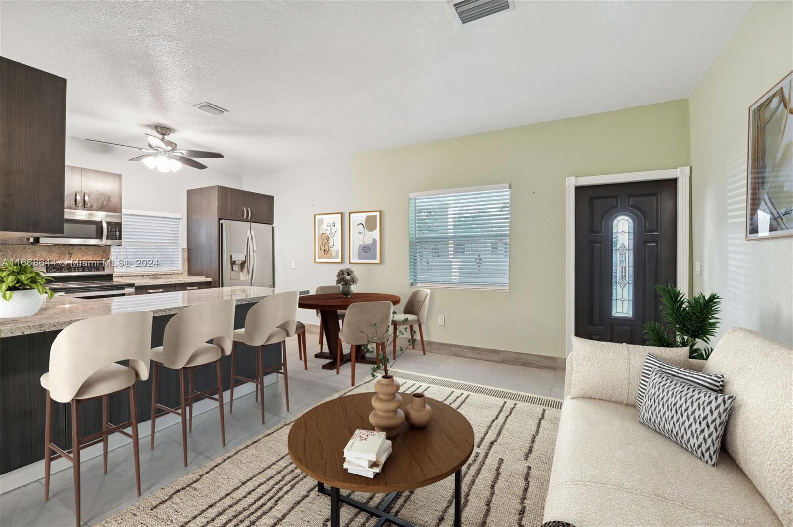 a living room with furniture kitchen view and a window