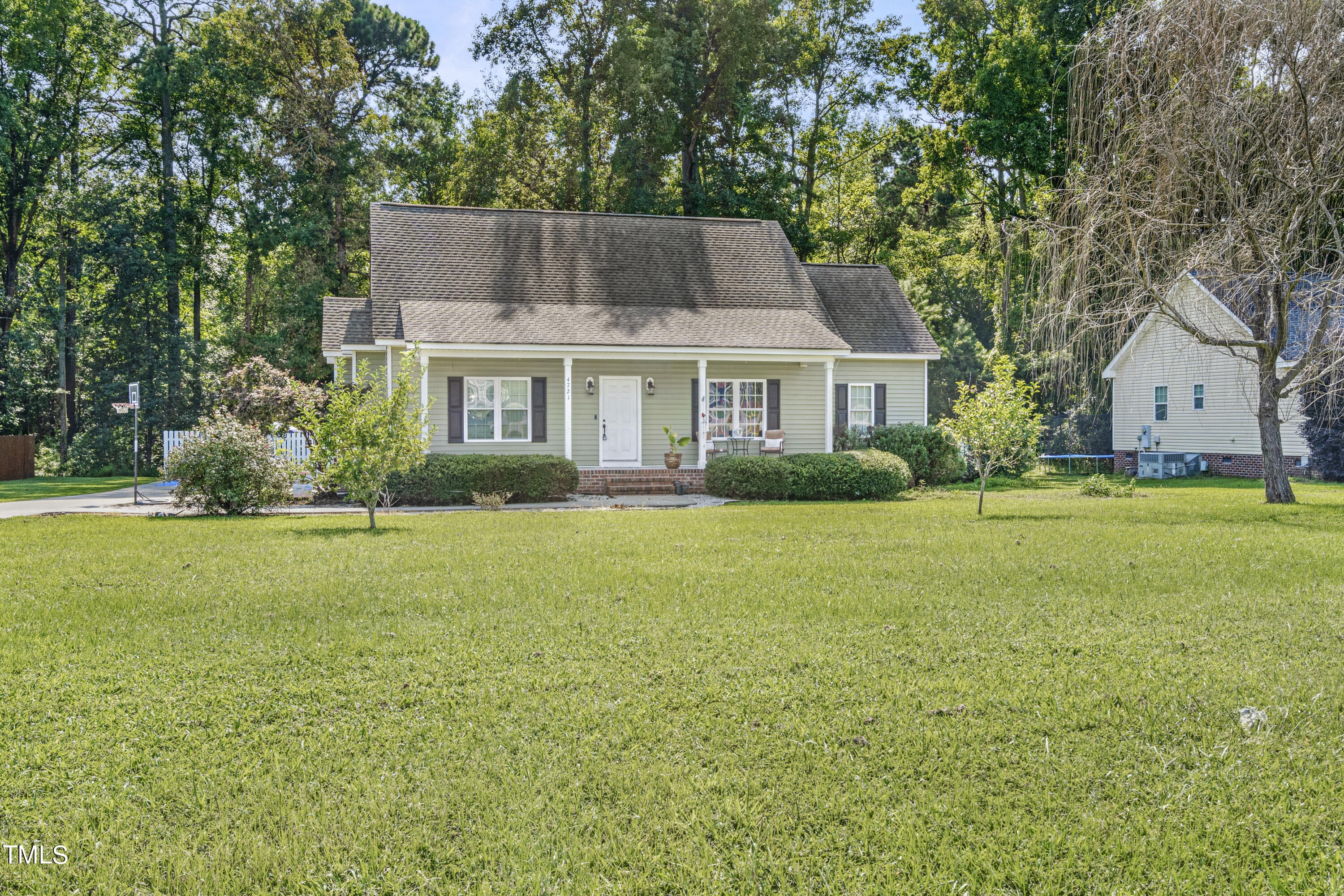 a front view of house with yard and green space