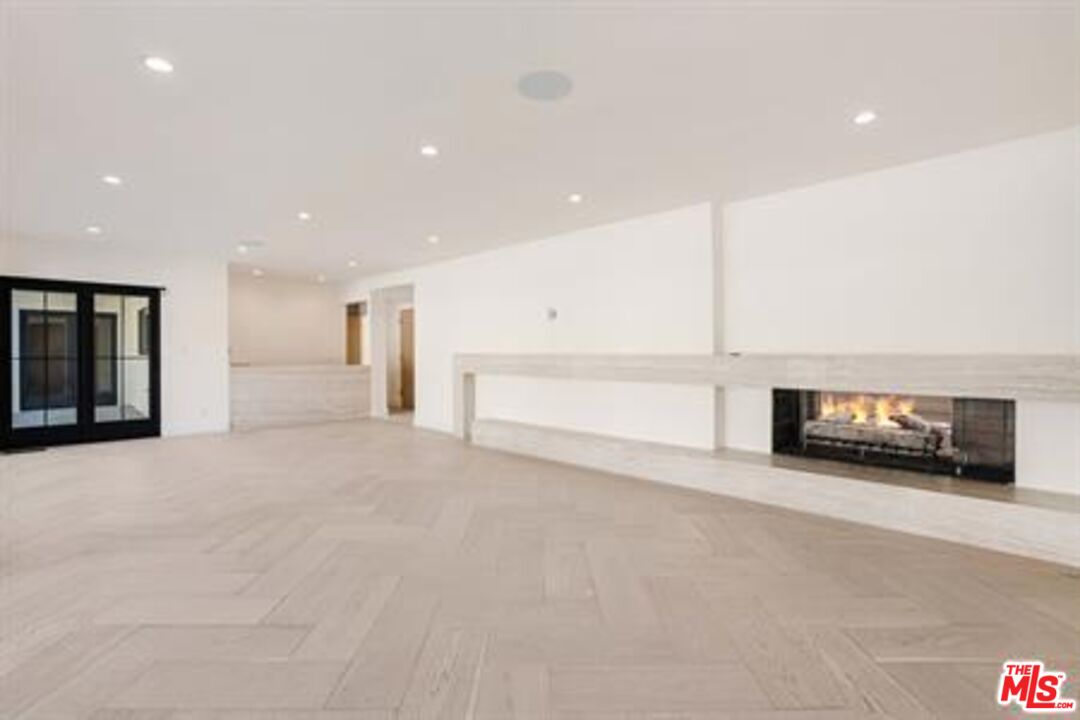 a view of an empty room with a fireplace