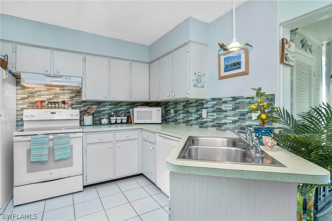 a kitchen with stainless steel appliances granite countertop a sink and a granite counter tops