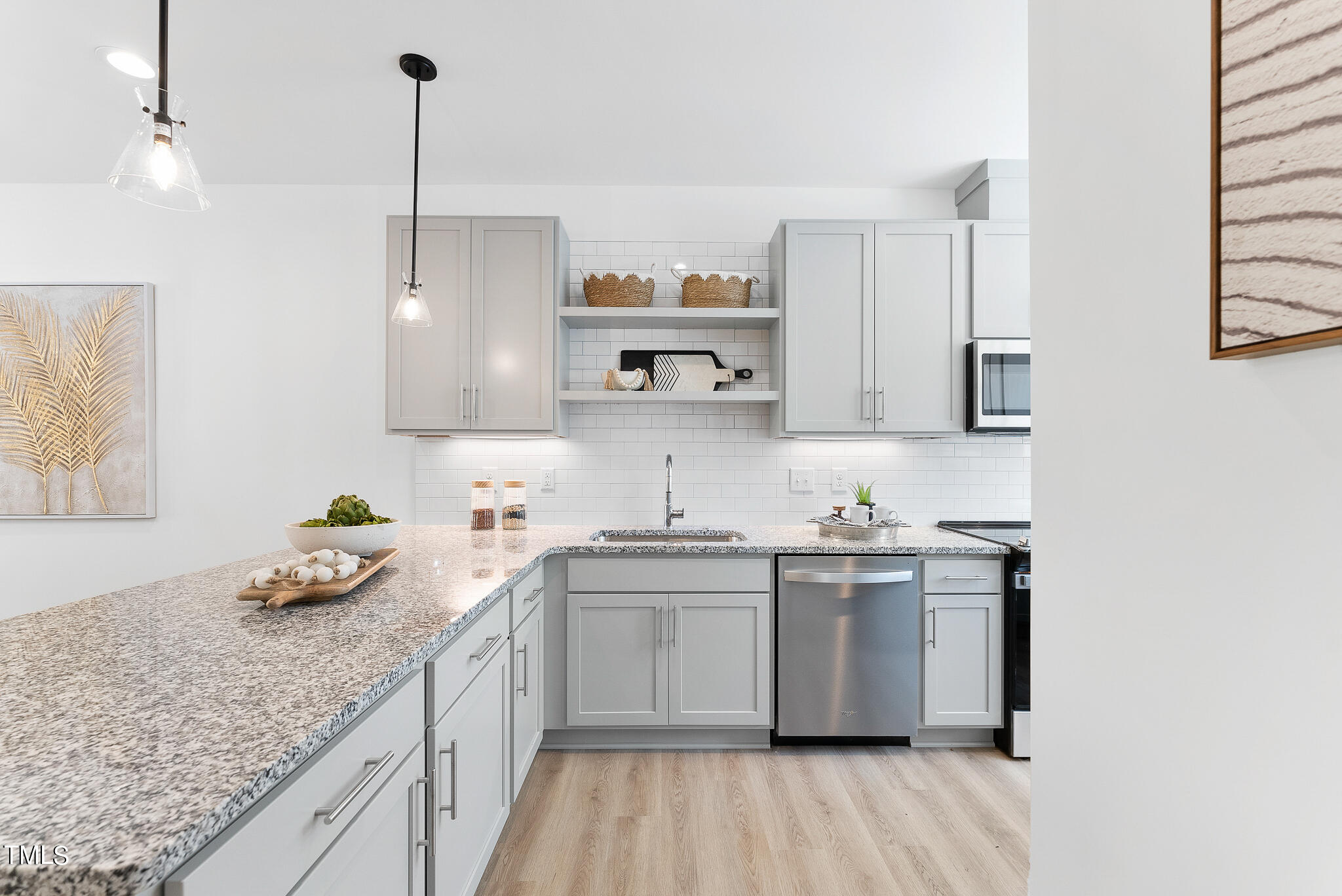 a kitchen with stainless steel appliances granite countertop a sink a stove and a wooden floors