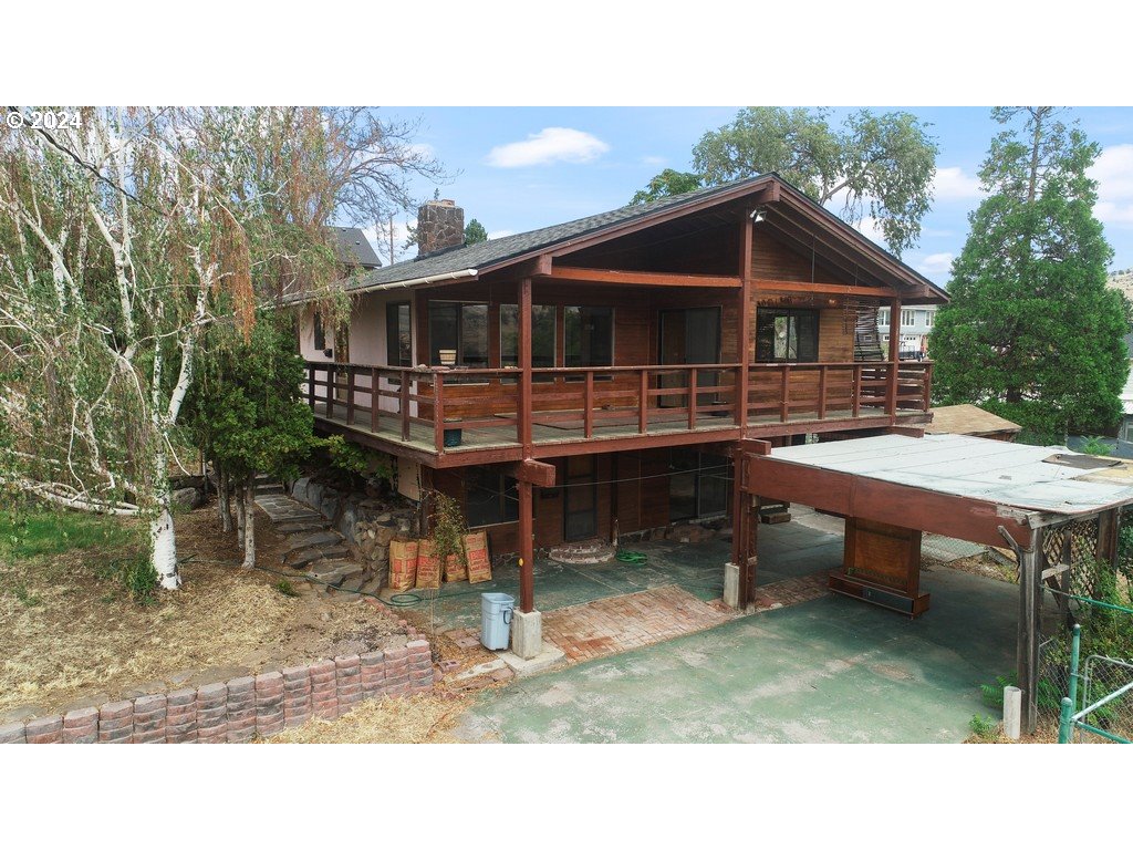 a backyard of a house with barbeque oven fire pit table and chairs