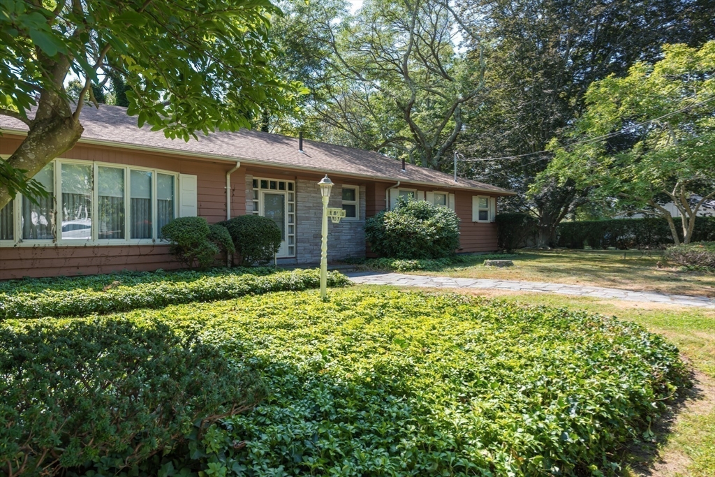 a front view of house with yard and green space