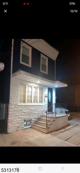 a front view of a house with lots of yellow lighting